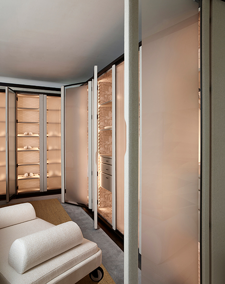 Wardrobe interior with tactile surfaces and softly lit details