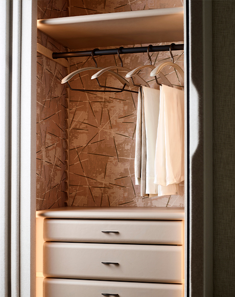 Wardrobe interior with tactile surfaces and softly lit details