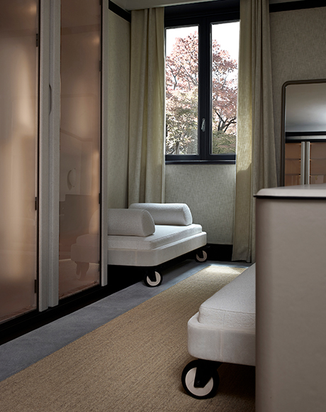 Wardrobe interior with tactile surfaces and softly lit details