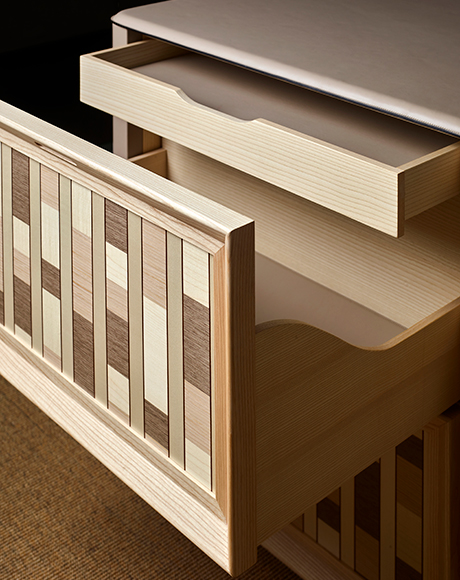 Wardrobe interior with tactile surfaces and softly lit details