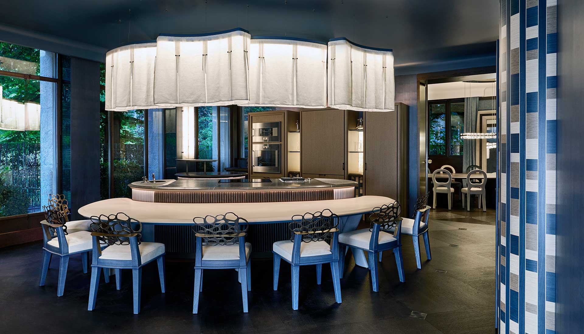 Kitchen interior with curved forms, stone surfaces and natural light